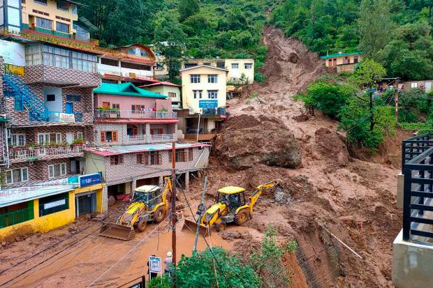 Earthmovers on restoration work as massive landslide damaged buildings at Shamti after heavy monsoon rainfall, in Solan district. (PTI Photo)