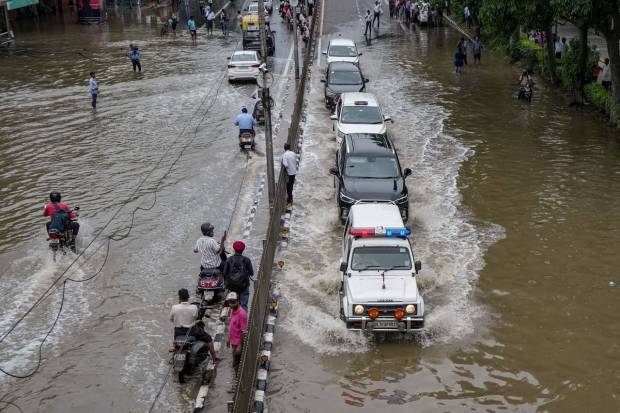 Delhi Chief Minister Arvind Kerjriwal's carcade moves through a waterlogged road at ITO in New Delhi. (PTI)