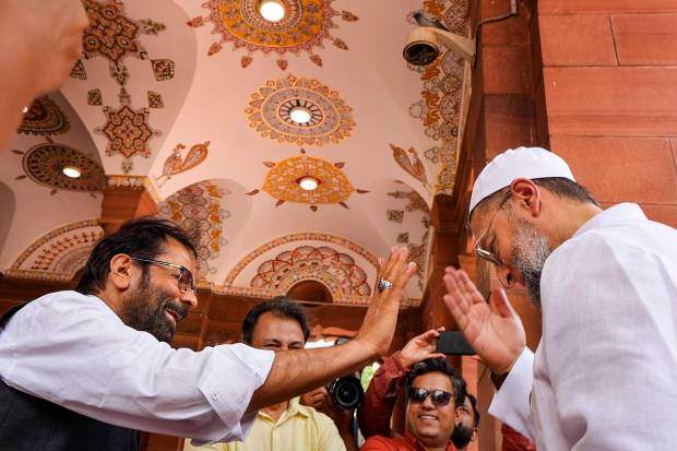 Former union minister Mukhtar Abbas Naqvi and AIMIM MP Asaduddin Owaisi on the first day of Monsoon session of Parliament, in New Delhi. (PTI Photo)