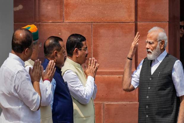 Prime Minister Narendra Modi being greeted by Union Ministers Pralhad Joshi, Jitendra Singh, Arjun Ram Meghwal and V Muraleedharan as he arrives to address the media on the first day of the Monsoon session of Parliament, in New Delhi. (PTI Photo)
