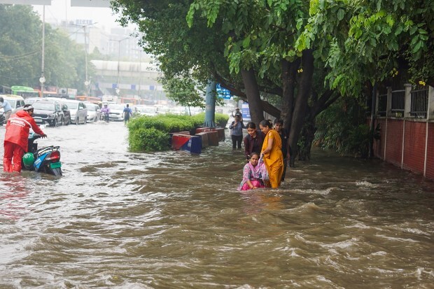 Vehicles pass through a waterlogged roas after heavy monsoon rains, at ITO in New Delhi on July 8. (Image: PTI Photo)