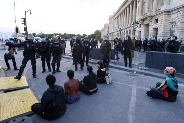 People protest in support of Nahel, a 17-year-old teenager killed by a French police officer during a traffic stop, at the Place de la Concorde square in Paris, France. (Image: Reuters/Yves Herman)