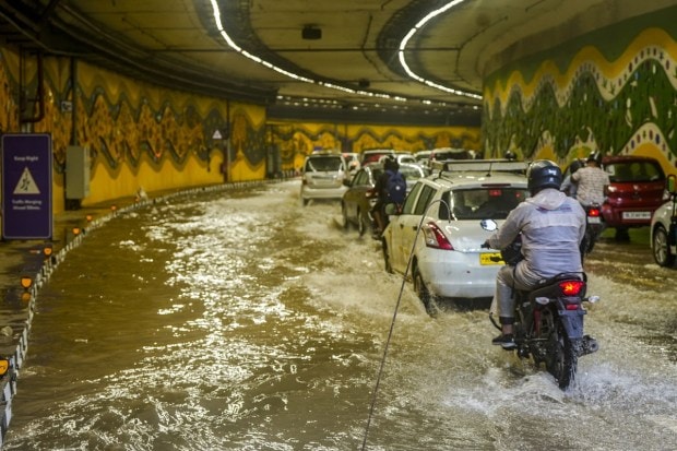 Vehicles pass through a waterlogged tunnel amid heavy monsoon rains, near Pragati Maidan in New Delhi. (Image: PTI Photo/Atul Yadav)