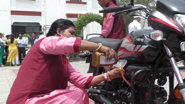 A women mechanic demonstrating her skills.