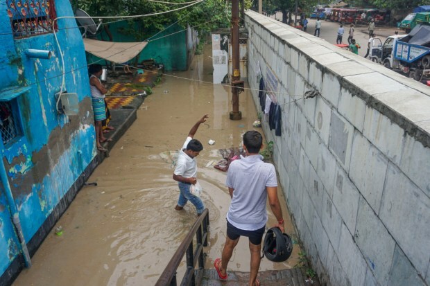 Residents at the flooded colony of Yamuna Bazar in New Delhi. (Image: PTI)