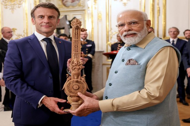 Prime Minister Narendra Modi gifts Sandalwood Sitar to French President Emmanuel Macron, in Paris on July 14, 2023. (Image: PTI Photo)