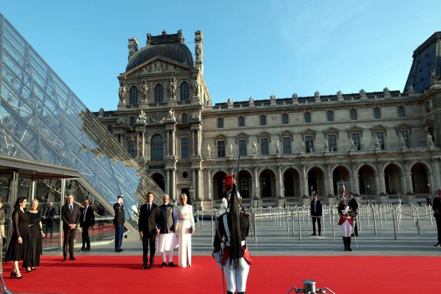 PM Modi with the French President Macron and his wife Brigitte Macron at the Louvre Museum, in Paris. (Image: PTI Photo)