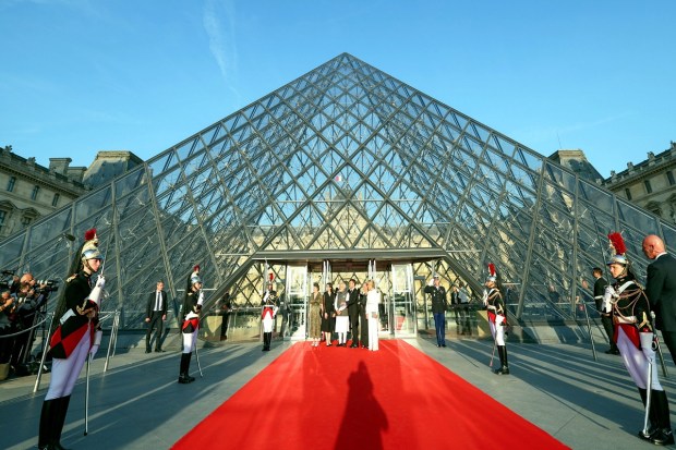 Prime Minister Narendra Modi with French President Emmanuel Macron and his wife Brigitte Macron at the Louvre Museum, in Paris. (Image: PTI Photo)