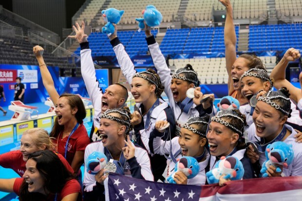 United States team members celebrate after winning silver in the team acrobatic final of artistic swimming. (Image: AP)