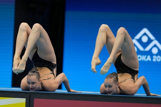 Ukraine's Maryna Aleksiiva and Vladyslava Aleksiiva compete in the women's duet free of artistic swimming. (Image: AP)