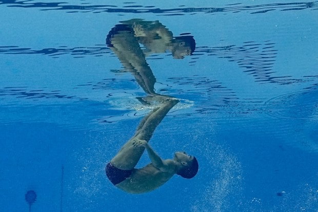 Kantinan Adisaisiributr of Thailand competes in the men's solo free of artistic swimming. (Image: AP)