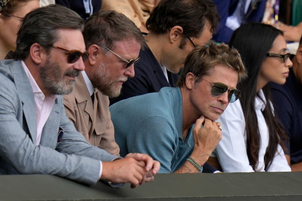 Actor Brad Pitt and director Guy Ritchie sit in the stands on Centre Court. (Image: AP)