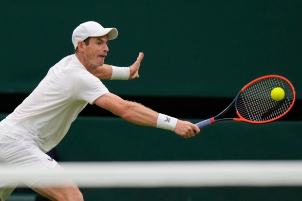  Murray returns to Peniston during a first round men's singles match. (Image: AP)