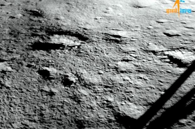 “The image captured by the Landing Imager Camera after the landing. It shows a portion of Chandrayaan-3's landing site. Seen also is a leg and its accompanying shadow. Chandrayaan-3 chose a relatively flat region on the lunar surface,” the space agency shared on X. (Image/ISRO)
