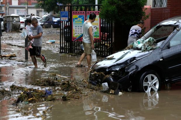 The nearby cities of Tianjin and Zhuozhou were also hit hard. Fire services aided by volunteer rescue groups searched apartment buildings and railway tunnels for stranded people, bringing hundreds to safety. (AP Photo)