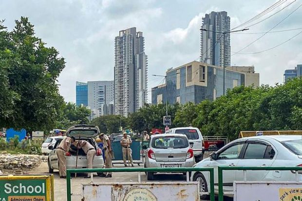 Police personnel check vehicles after incidents of violence following Monday's attack on a procession in adjoining Nuh district, near Maidawas in Gurugram. (Photo Credits: PTI)