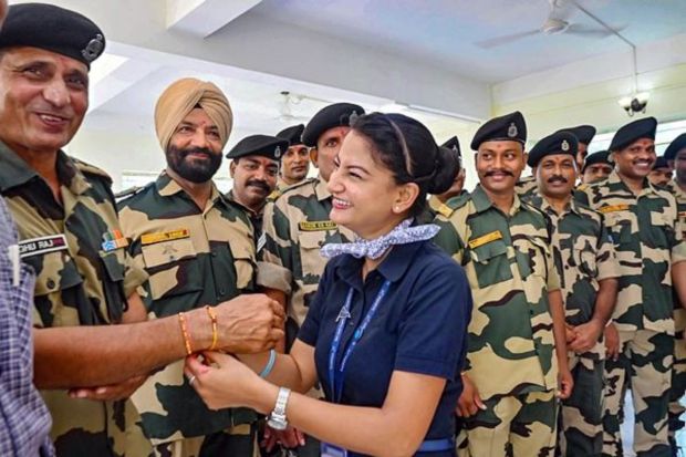 Women tie 'rakhi' on the wrist of Border Security Force (BSF) personnel during the 'Raksha Bandhan' celebrations, at the Indo-Bangladesh Border near Agartala. (PTI Photo) 