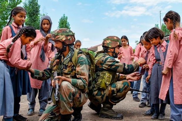 School girls tie 'rakhi' on the wrists of Indian Army soldiers during celebrations of 'Raksha Bandhan' festival, in Poonch. (PTI Photo)