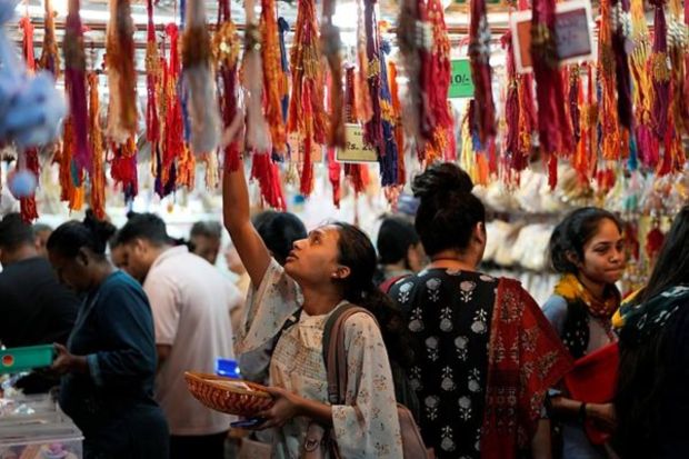 Women shop for Rakhi, a sacred thread, on the eve of the Raksha Bandhan festival in Ahmedabad in India. (AP Photo)