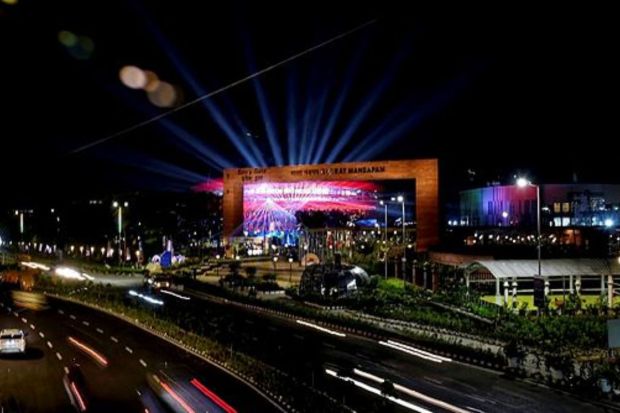 Vehicles move past Bharat Mandapam illuminated in the Indian Tricolour ahead of the G20 summit in New Delhi. (PTI Photo/Manvender Vashist Lav)