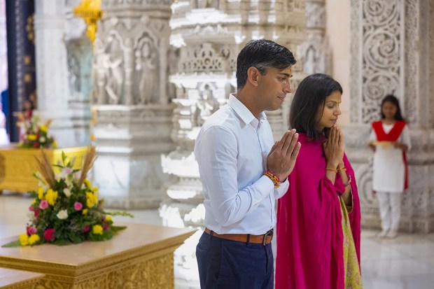 Sunak and Murty offering prayer inside the temple. (Image: PTI)