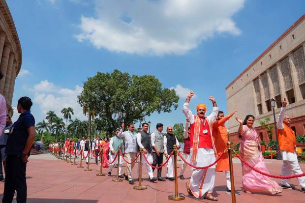 Parliamentarians walk towards the new Parliament building, in New Delhi. (PTI Photo)