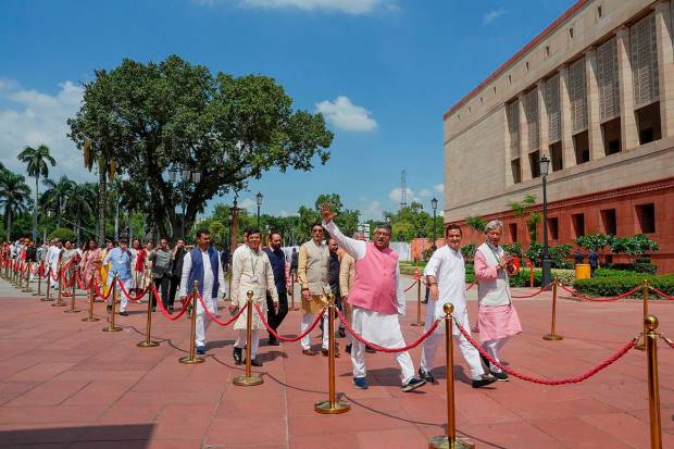 Parliamentarians walk towards the new Parliament building, in New Delhi. (PTI Photo)