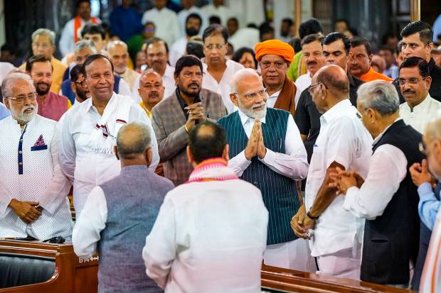 Prime Minister Narendra Modi greets NCP President Sharad Pawar and others during an event organised in the Central Hall of Parliament on the occasion of the shifting of Parliament to the new building, in New Delhi. (PTI Photo)