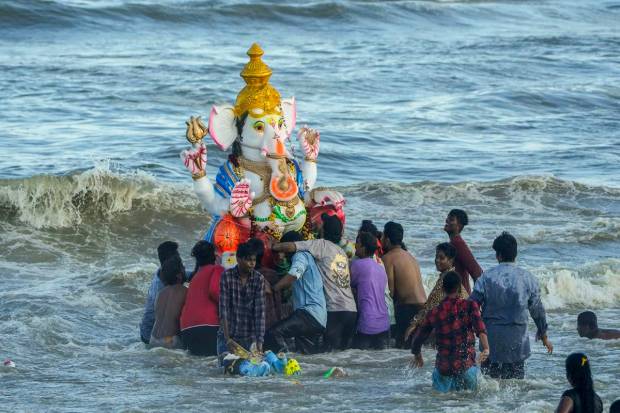Devotees immerse a Lord Ganesha idol at the Pattinapakkam beach during Ganesh festival, in Chennai. (PTI Photo)