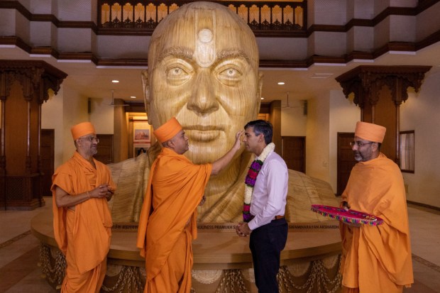 Sunak was garlanded by six priests on behalf of the sixth spiritual guru and president of Bochasanwasi Akshar Purushottam Swaminarayan Sanstha, Mahant Swami Maharaj. (Image: PTI)