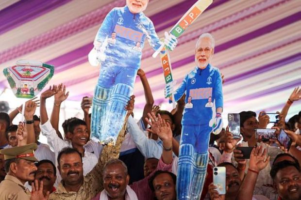 Supporters hold cut-outs of PM Modi during the foundation stone laying ceremony of International Cricket Stadium yesterday. The Uttar Pradesh government has spent Rs 121 crore on land acquisition for the stadium while the BCCI will spend a further Rs 330 crore on its construction. (PTI Photo)