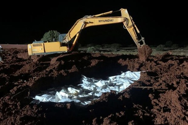 Victims wrapped in body bags and blankets were buried together in a cemetery. (Image: AP News)