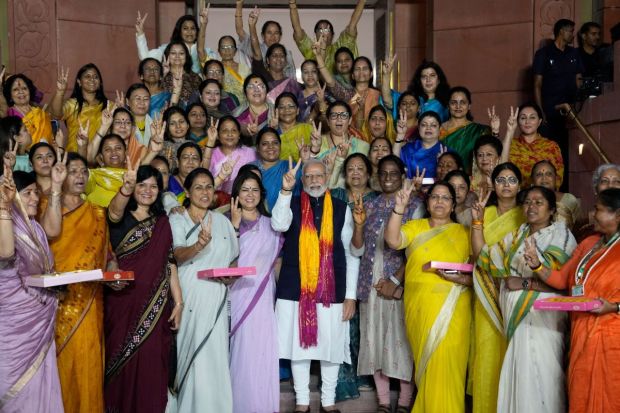 PM Modi flashes victory sign with women MPs after the passage of the Nari Shakti Vandan Adhiniyam (women's reservation bill) by the Rajya Sabha in the special session of the Parliament on Thursday. (PTI Photo/Arun Sharma) 