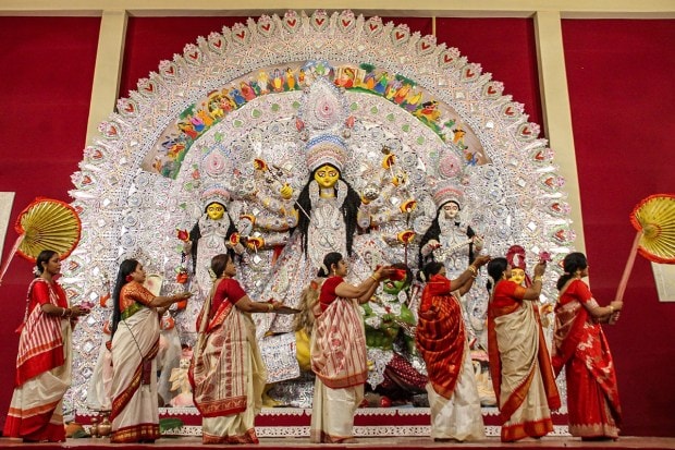 Devotees offer prayers to the idol of goddess Durga during Durga Puja Festival at a community centre of Sector 15 in Gurugram. (PTI Photo)