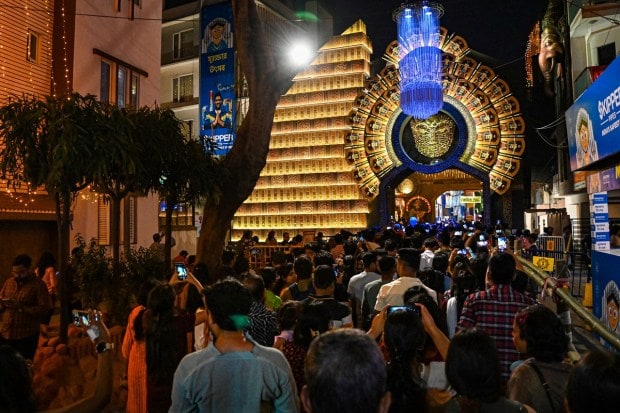Devotees at a community 'puja pandal' during 'Maha Sasthi' of Durga Puja festival, in Kolkata. (PTI Photo)
