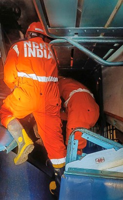 NDRF and other emergency services personnel conduct rescue operation after multiple coaches of two passenger trains derailed following a collision, in Vizianagaram district. (PTI Photo)