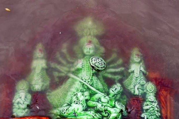 An idol of goddess Durga being immersed (Visarjan) on the banks of river Ganga on ‘Vijayadashami’ marking the end of the Durga Puja festival in Kolkata on October 24. (Image: PTI)