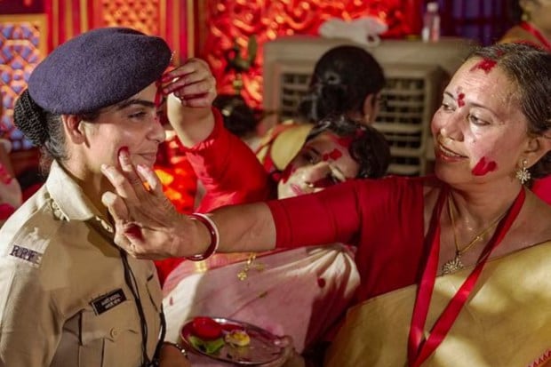 Women apply vermillion on police personnel as they participate in 'Sindoor Khela' in Mumbai. (Image: PTI)
