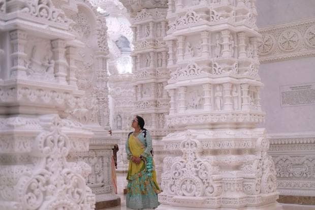 A woman admires the intricate architecture of the BAPS Swaminarayan Akshardham. (AP Photo)