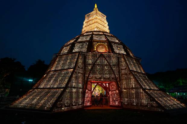 A community puja pandal designed in the shape of a bell in Kolkata. (PTI Photo)