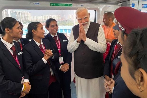 PM Modi interacts with the crew of the Regional Rapid train 'Namo Bharat' connecting Sahibabad and Duhai Depot stations. (PTI Photo)