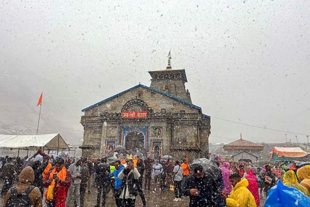 Devotees at Kedarnath Temple amid snowfall, in Rudraprayag district. (PTI Photo)