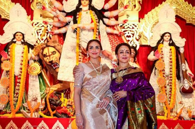 Actors Hema Malini and Esha Deol pose for photos at a pandal of North Bombay Sarbojanin Durga Puja, in Mumbai. (PTI Photo) 
