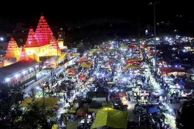 A Durga Puja pandal themed on the Shri Mahalaxmi Temple of Kolhapur illuminated during the Navratri festival in Bhopal. (PTI Photo)