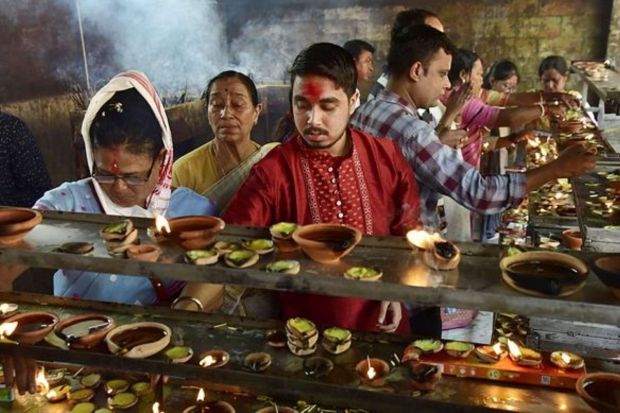 Devotees light earthen lamps at the Kamakhya temple during ongoing Navratri festival in Guwahati. (PTI Photo)