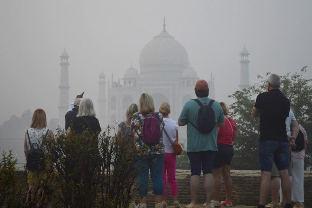 Tourists visit the Taj Mahal amid dense smog in Agra Tuesday on Tuesday. (PTI Photo)