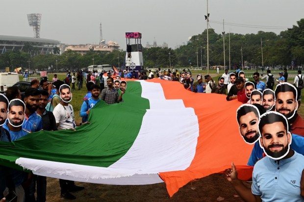 Fans were waiting for his century with much anticipation. Here a large number of fans are seen wearing masks of Virat Kohli , as they carry the Indian tricolour while entering enter the stadium to watch India's match against South Africa. (PTI Photo)