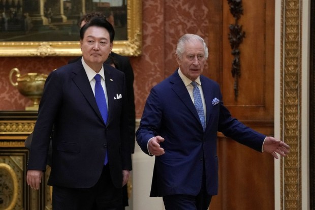 Britain's King Charles and President of South Korea Yoon Suk Yeol walk as they look at a display of Korean items from the Royal Collection. (Reuters Photo)