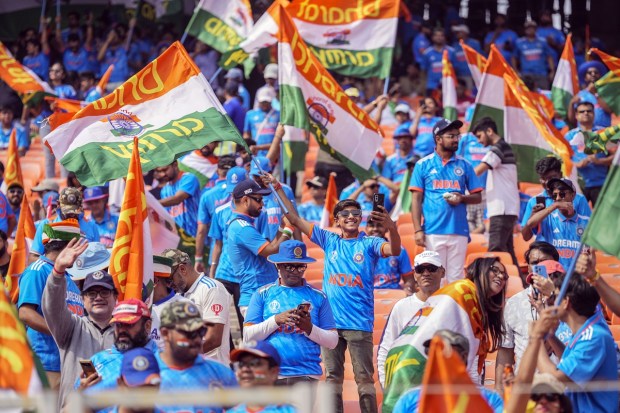Indian fans carry placards as they wait for the ICC Men's Cricket World Cup final match between Australia and India to begin in Ahmedabad. (PTI Photo)