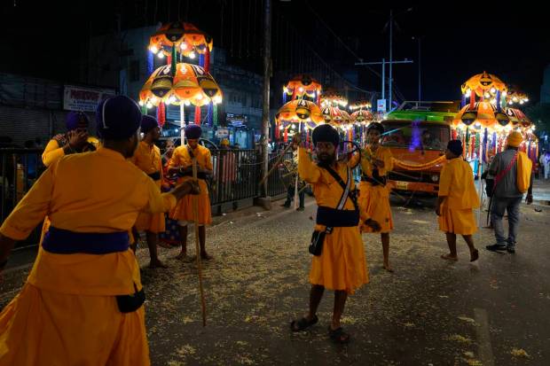 Sikh warriors display traditional martial art skills during a religious procession ahead of the birth anniversary of the first Sikh guru, Guru Nanak, in Hyderabad. (AP Photo)